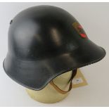 A 1970s Swiss Bern Fire Service black steel fire helmet