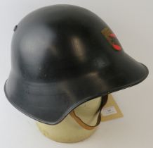 A 1970s Swiss Bern Fire Service black steel fire helmet