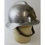 A 1970s Danish Fire Service steel fire helmet with brass badge