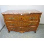 A late 18th/early 19th century Louis XV style walnut serpentine commode chest, having a rouge marble