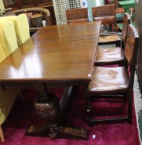 An oak drawer leaf dining table together with four leather single chairs