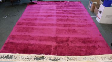 A room sized red ground Chinese washed wool floral textured carpet 266 x 357cm