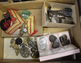 A collection of cap badges, wartime relics, cloth insignia coins etc