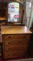 An oak mirror back four drawer dressing chest