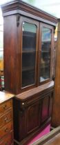 A Victorian mahogany bookcase with glazed upper section on a cupboard base