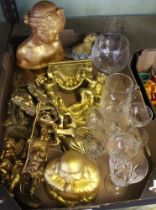A collection of gilded ornaments includes a Buddha and some glassware
