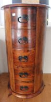 A small barrel chest of five drawers