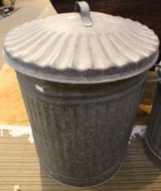 A vintage galvanised dustbin with lid