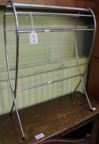 A modernist chromed tear drop magazine rack