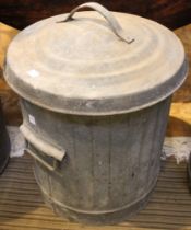 A small galvanised dustbin with lid