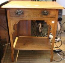 An oak side table with single drawer and an under tier