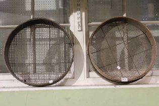 A pair of vintage wooden garden sieves