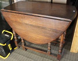 An oak oval dropleaf dining table