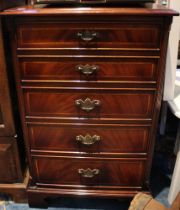 A reproduction mahogany cabinet with single door revealing fitted interior