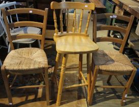 A pair of rush seated single chairs and a pine bar stool