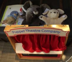 A wooden child's puppet theatre company two hand puppets and a Peter Rabbit book