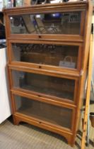 A Globe Wernicke style four graduating shelf book case in light oak