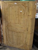 A bamboo strip covered corner cupboard with two glazed shelves