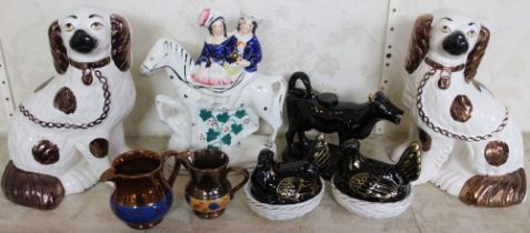 A pair of pottery mantel dogs, Black Jackfield cow creamer and miniature hens, a 19th Century Staffo