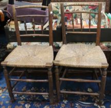 A pair of 19th century rush seated chairs with turned bobbin backs
