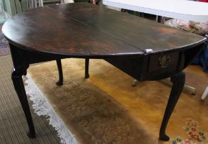 An 18th century mahogany drop leaf circular supper table, fitted single frieze end drawer, raised on