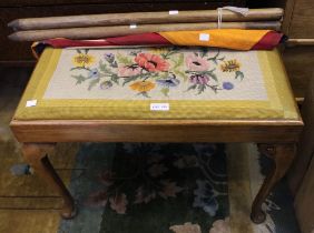 A tapestry top piano stool with a vintage kite and cricket stumps