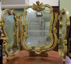 A triple folding gilt framed dressing table mirror