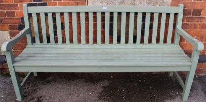 A light green painted wooden slatted three seater garden bench