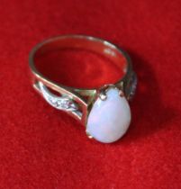 An 18ct gold ring set tear drop Opal and diamonds to the shoulders