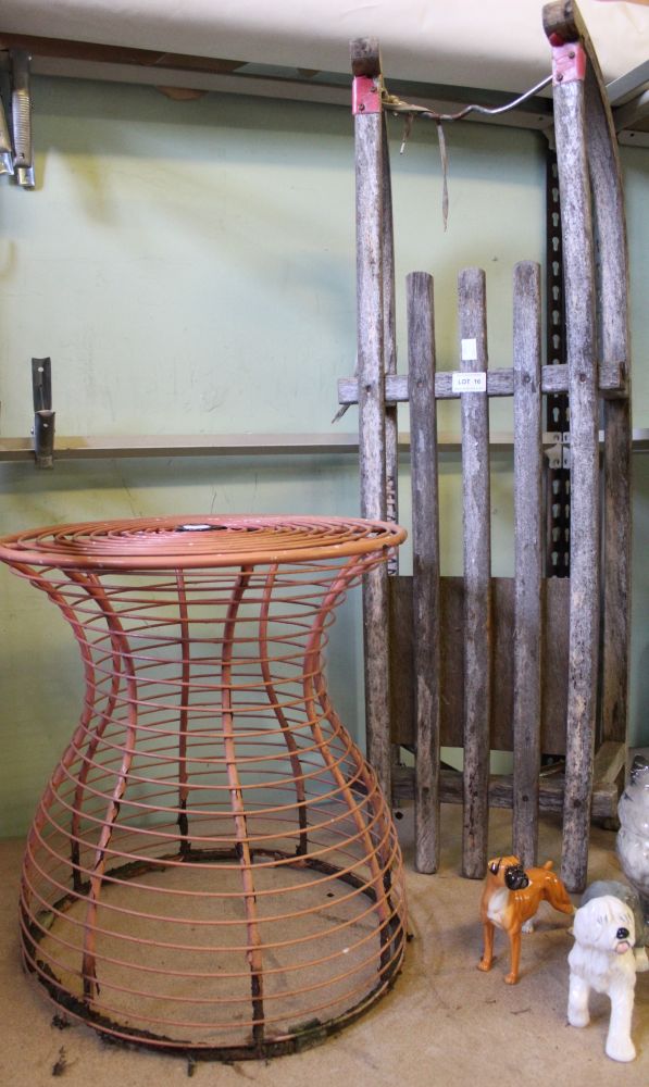 A vintage wooden sledge together with a metal small circular garden table