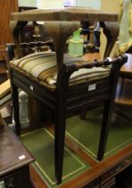 A piano stool with a small leather topped foot stool