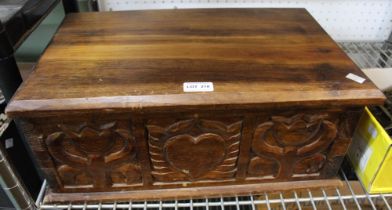 An imported hardwood box with carved panels front and rear