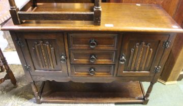 An Old Charm style low sideboard with three central drawers and low under tier