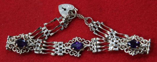 A 9ct gold gate link bracelet, purple stone set, fitted 9ct gold padlock clasp gross weight 7.9g