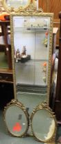 A pair of metal framed oval wall mirrors and a gilt framed robing mirror