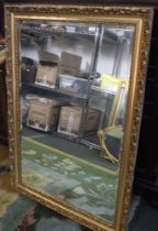 A large modern bevel edged gilt framed wall mirror