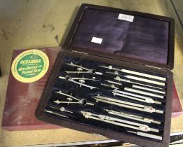 A vintage cased geometry set with an old boxed scrabble game