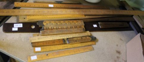 A good selection of wooden set squares, rulers including folding examples