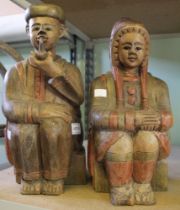 A pair of carved wooden folk art ethnographic figures