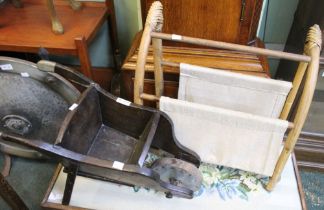 A bamboo magazine rack with a miniature wheel barrow