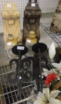 A pair of wall mounted candle sconces with two carved wooden wall mounted brackets and