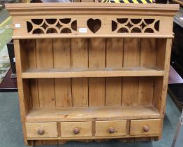 A pine wall hanging shelf with four small drawers