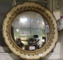 A 20th century small circular convex mirror in decorative frame