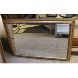 A large bevel edged rectangular gilt frame wall mirror
