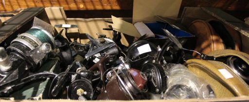 A box containing a large selection of fishing reels, including two ABU 506 closed face and Mitchel