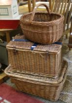 Two wicker storage baskets with a traditional wicker shopping basket