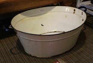 A vintage enamel twin handled large wash bowl