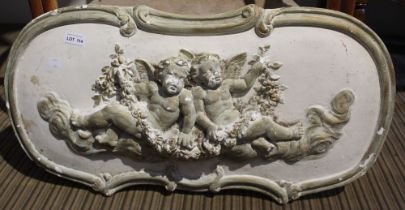 A plaster wall hanging freeze of a pair of cherubs