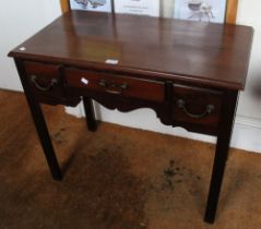 A Georgian design mahogany three drawer low boy with reeded column legs