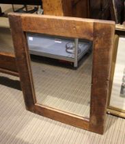 A rustic framed rectangular wall mirror